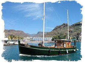A boat heading for Puerto Mogan harbour